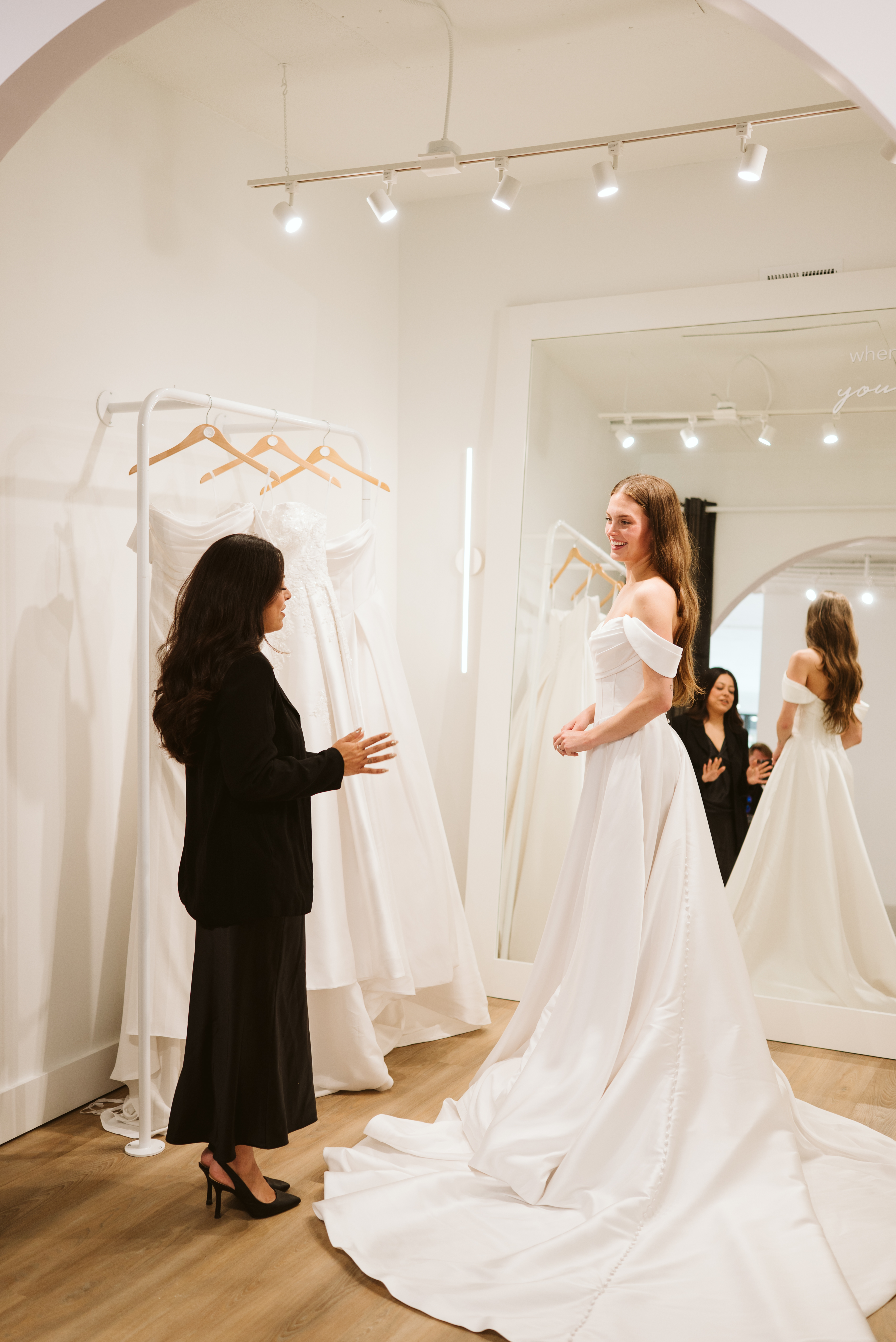 A bridal consultant at Luxe Redux helps a bride find the dress of her dreams.